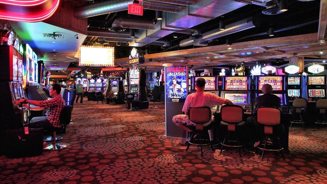 Slot machines on a red-lit Las Vegas casino floor at night — Killer's Diary free daily crypto slot review