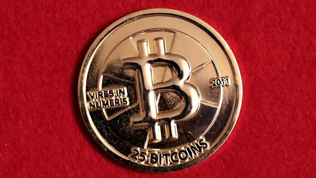 Physical gold Bitcoin coin — Bitcoin's first weekly close above its 50-week moving average since November 2025