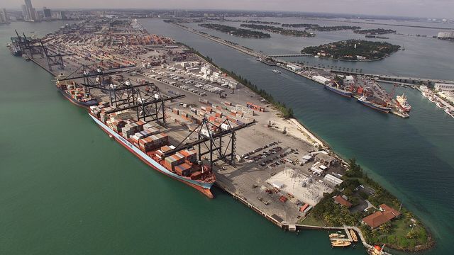 Aerial view of the Port of Miami container terminal — XDC Network’s trade-finance rails head into Sibos Miami 2026, where Contour convenes SAP, Accenture and GLEIF