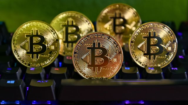 Gold bitcoin coins lined up on a backlit keyboard — Jupiter Faucet review: 0.15 free JUP every 15 minutes with instant Phantom withdrawal on Solana