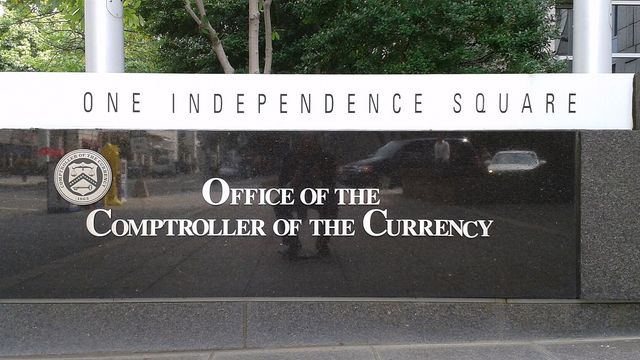 Office of the Comptroller of the Currency sign at One Independence Square — the OCC national trust charter rule faces an ICBA lawsuit as Rain applies