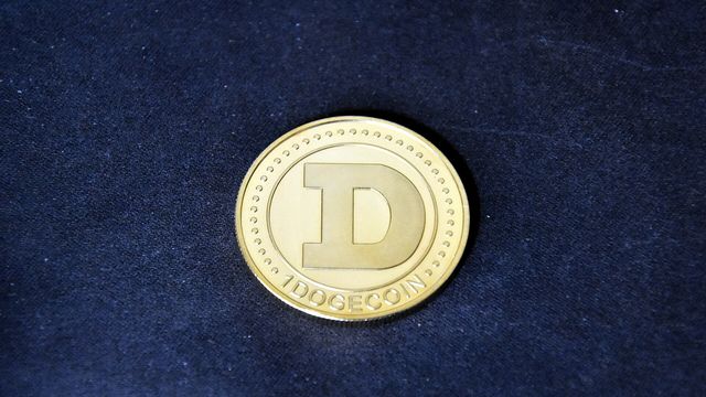 Gold physical cryptocurrency coin on a black background - EARN token presale on EarnCrypto