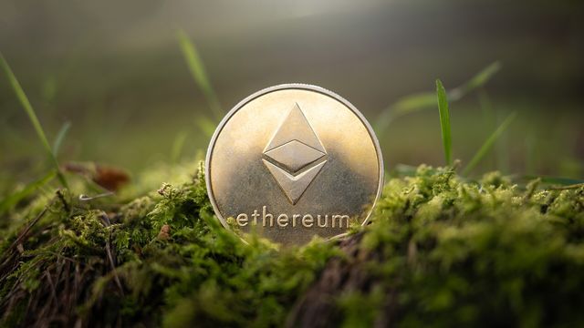 A physical Ethereum coin resting on moss — Aero's October 21 launch across seven EVM chains, with 100% of exchange revenue routed to AERO stakers