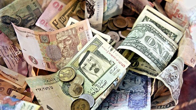 Mixed international banknotes from several countries — Earn Crypto by Country: 41 country guides with local taxes and electricity prices