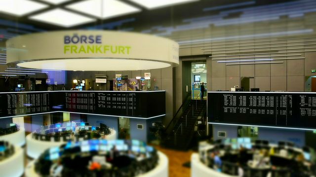 The trading hall of the Frankfurt Stock Exchange with its electronic quote board — Nasdaq Basic equity market data is now distributed through Pyth's Data Marketplace
