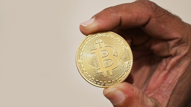 Hand holding a physical cryptocurrency coin — NEAR@3.33 airdrop milestone and the $3.33 VWAP conversion trigger