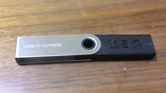 A Ledger Nano S hardware wallet used for self-custody crypto storage — Starknet STRK breakout, strkBTC shielded Bitcoin and 800 million staked tokens