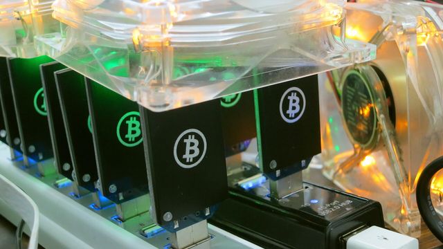 Bitcoin ASIC mining hardware stacked in a mining array — BitForge AI 1.4.3 cross-chain BTC mining review