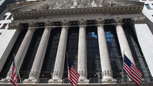 New York Stock Exchange facade with US flags — JPMorgan's JPM Coin deposit token goes live on Ethereum