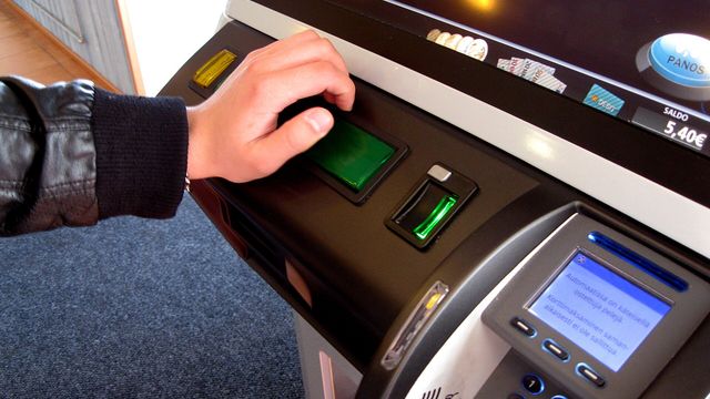 A player pressing the spin button on a video slot machine — Zombies Paid My Neighbors, the free 5x3 crypto cabinet on the EarnCrypto slots floor