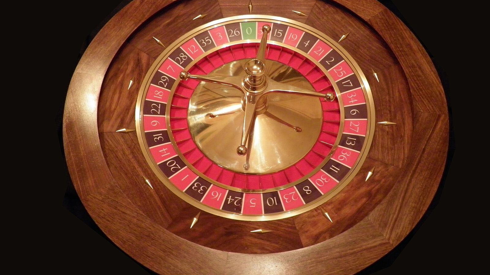 Roulette wheel on a casino floor — Space X Mission, EarnCrypto's free crash game on a floor of 11 games played from one wallet