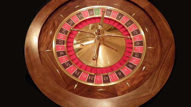 Roulette wheel on a casino floor — Space X Mission, EarnCrypto's free crash game on a floor of 11 games played from one wallet