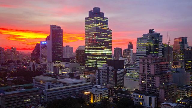 Bangkok's Silom financial district skyline at sunset — Thailand's SEC opens the Stock Exchange of Thailand to Bitcoin and Ether ETFs on October 16