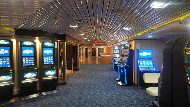 Slot machines on a casino floor at night — Gates of Hades: From Hell free daily crypto slot review
