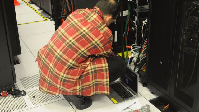 Technician working on a server rack at a data centre — Avalanche's Helicon upgrade rewrites validator staking economics with 48-hour lock-ups