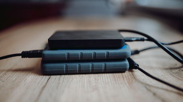 Stacked external hard drives — Arweave's AR token ran 66% in two sessions and the $4.19 retrace that decides whether $5.53 or $3.70 comes first