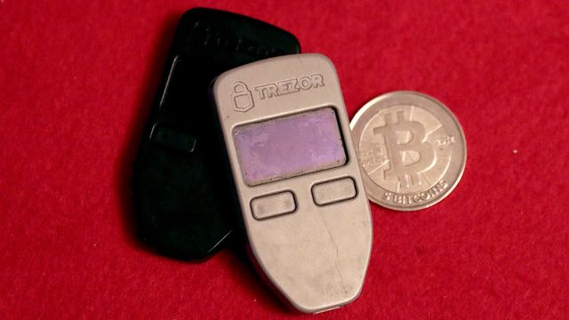 Two hardware wallets and a physical Casascius bitcoin coin — 81% of bitcoin supply has sat dormant for six months