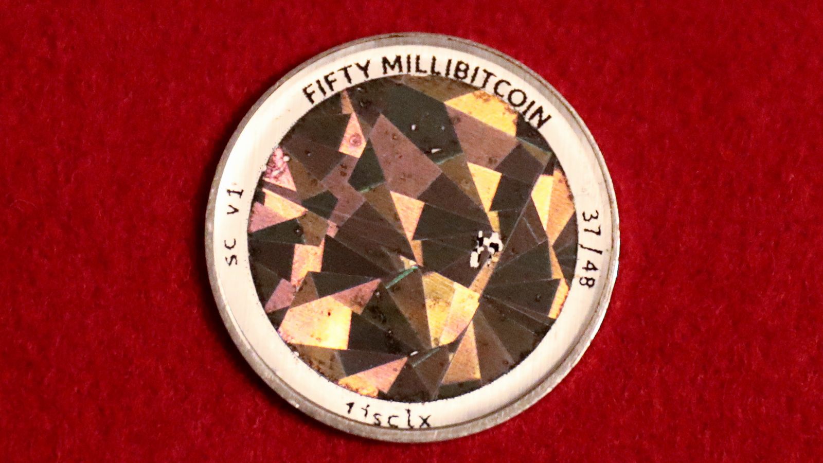 Back of a physical .05 BTC Serp coin on a red backdrop — Sanctum is set to burn 259 million SANC, a quarter of its supply, in October