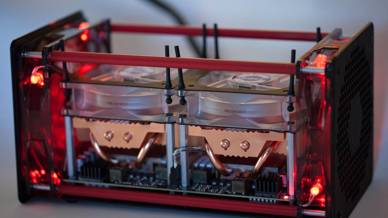 An open-frame Bitcoin mining rig with two red-lit GPUs — NullPool local secp256k1 mempool engine review