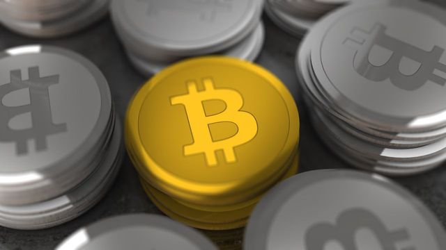 Gold and silver crypto coins in close-up — Monero's best month in five years and the $550 gate