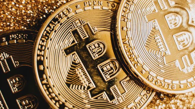 Three bitcoin coins on a sparkling gold surface — TIA's 31% week on 7x volume and the $0.4236 flip zone