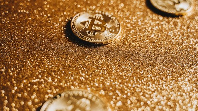 Bitcoin coins on a shimmering gold background — BTC double-topped at $81.5K with the neckline in control