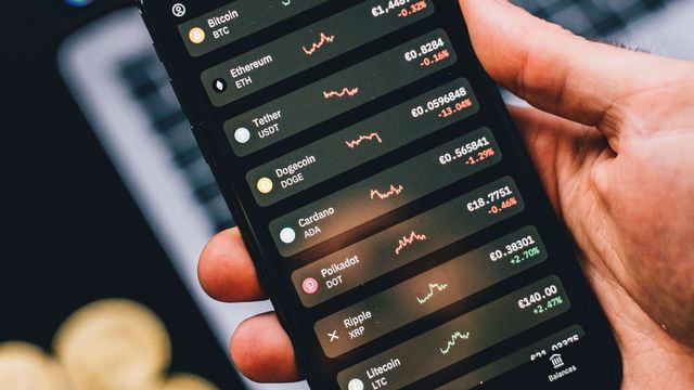 Crypto coins under coloured light — Aptos turning transaction fees into a burn engine
