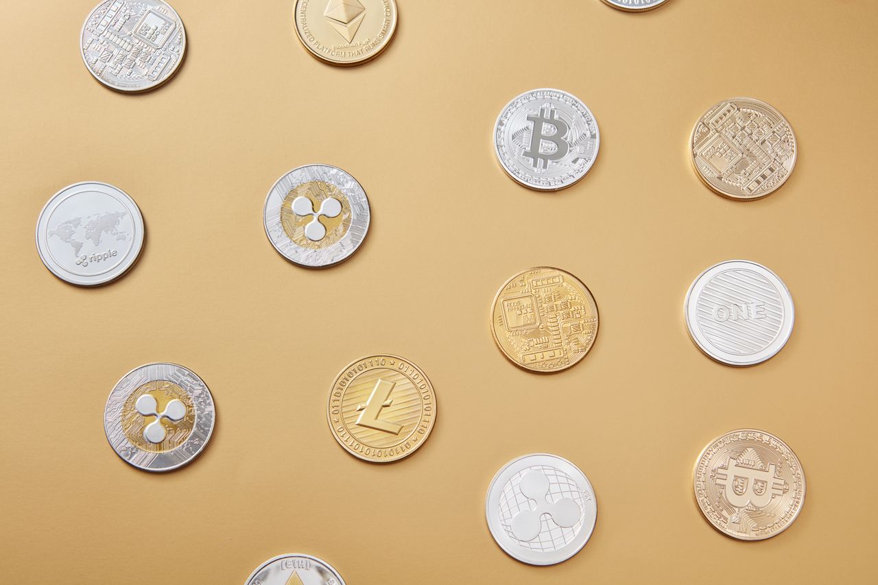 A flat lay of altcoin tokens on gold — BNB double-topped at $726 with the $680 neckline in play