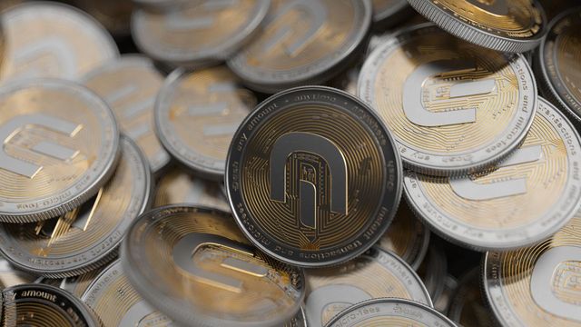 Close-up of gold and silver crypto coins — Flare cutting inflation 40% and burning 10x more FLR