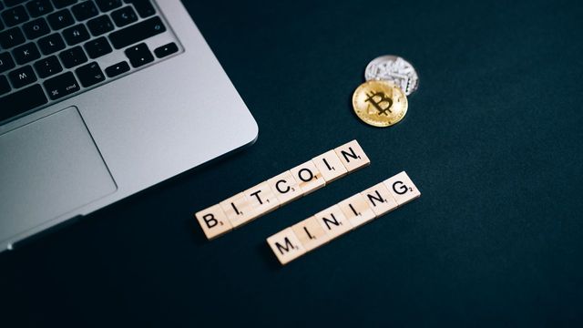 Bitcoin mining concept with a laptop keyboard and letter tiles — the unconfirmed bitcoin transaction loophole