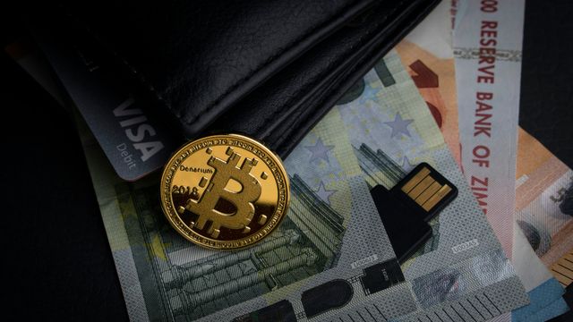Bitcoin sitting on a pile of money — crypto earnings setup