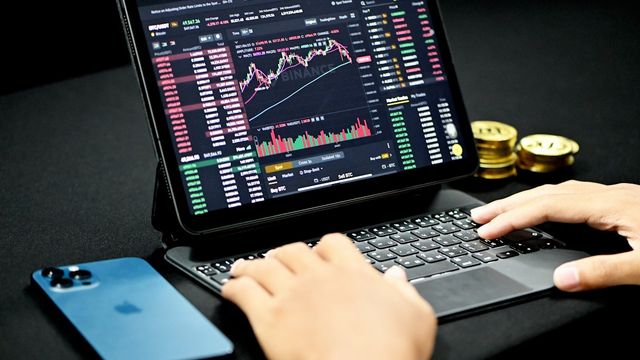 A person using a laptop computer — shipping a premium crypto site with V-Crypto Builder, no code
