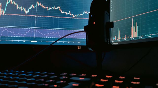 Cryptocurrency markets displayed on two monitors — Bitcoin's Q3 gain and the October seasonality map into Q4