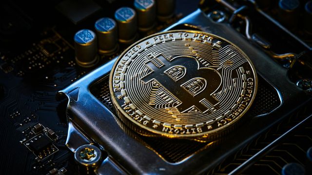 A bitcoin on a computer motherboard — 576 days to the next bitcoin halving and the live block-height countdowns